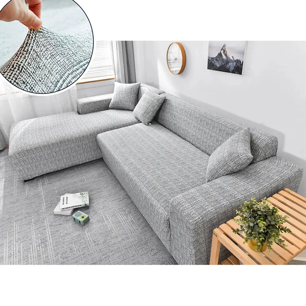 Sofa cover for L-shaped corner sofa in gray stretch fabric; elastic slipcover.