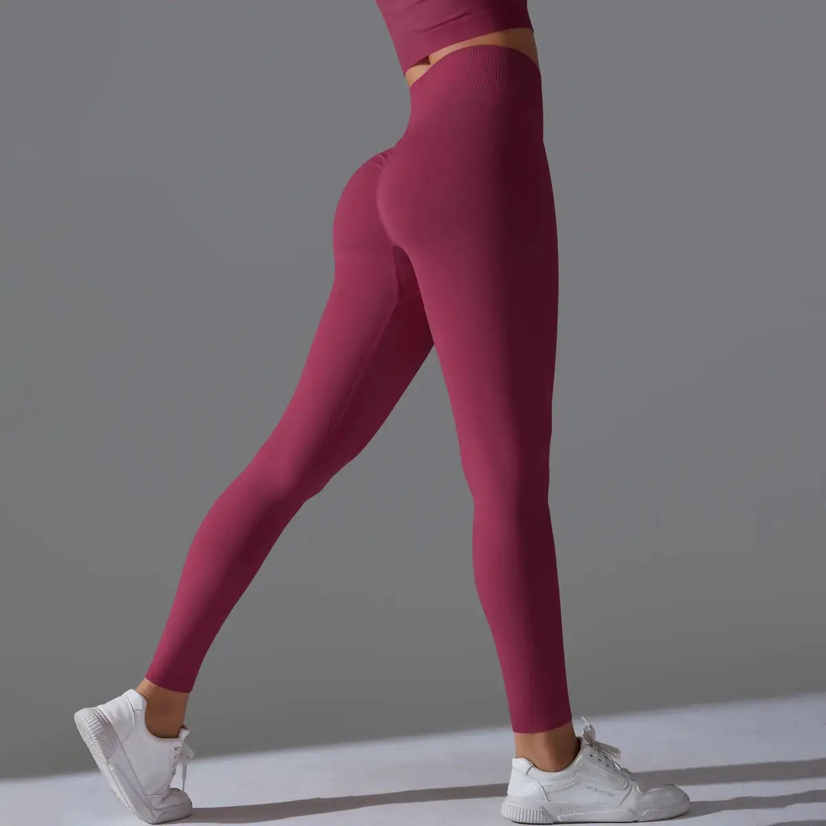 Women's seamless high-waist yoga leggings in magenta with tummy control and scrunch butt lift
