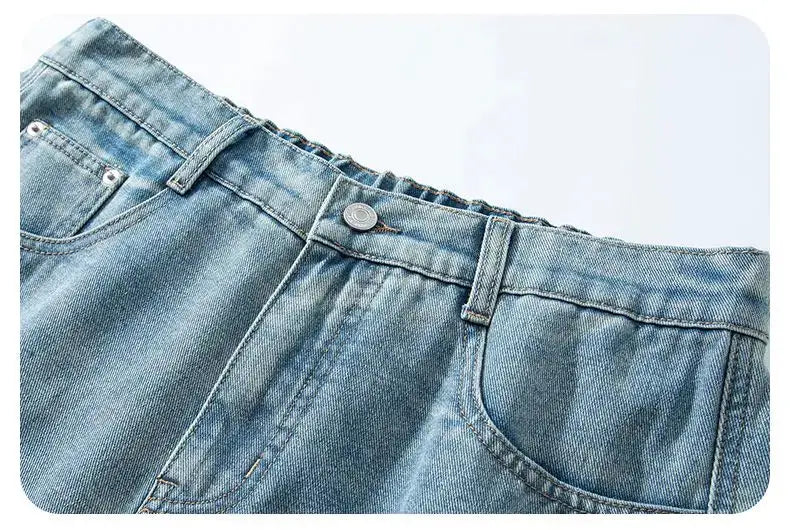 Denim shorts by Simples Market, baggy straight-fit with vintage wash light-blue denim.
