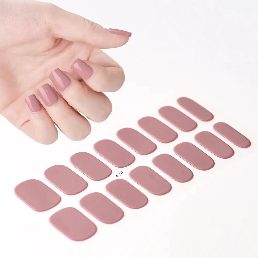 Mauve pink nail wrap decals for full-coverage nails, arranged in rows beside a hand with matching manicure