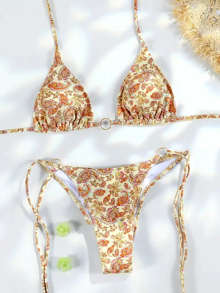 Bikini set by Simples Market: triangle top with ring accents, cream paisley print, thong bottoms