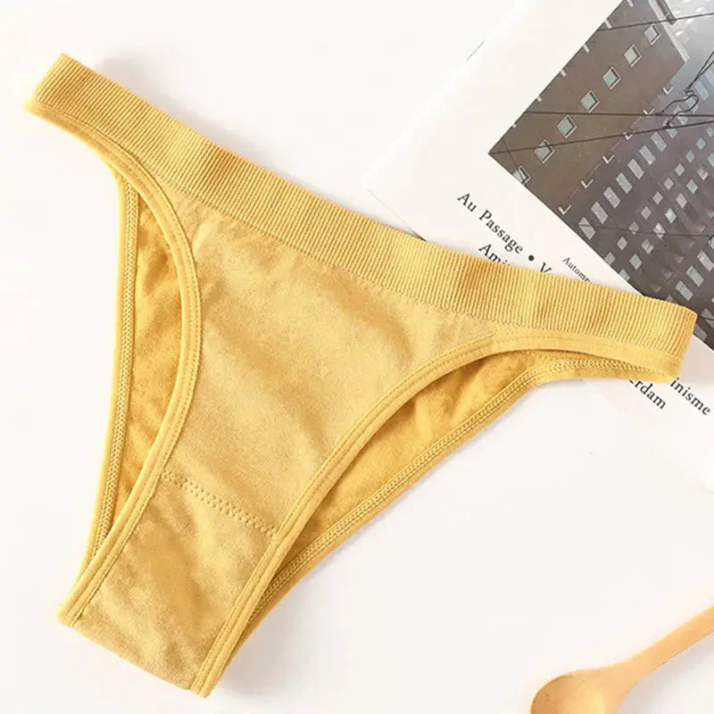 Women yellow ribbed thong underwear with high-leg cut and breathable cotton gusset.