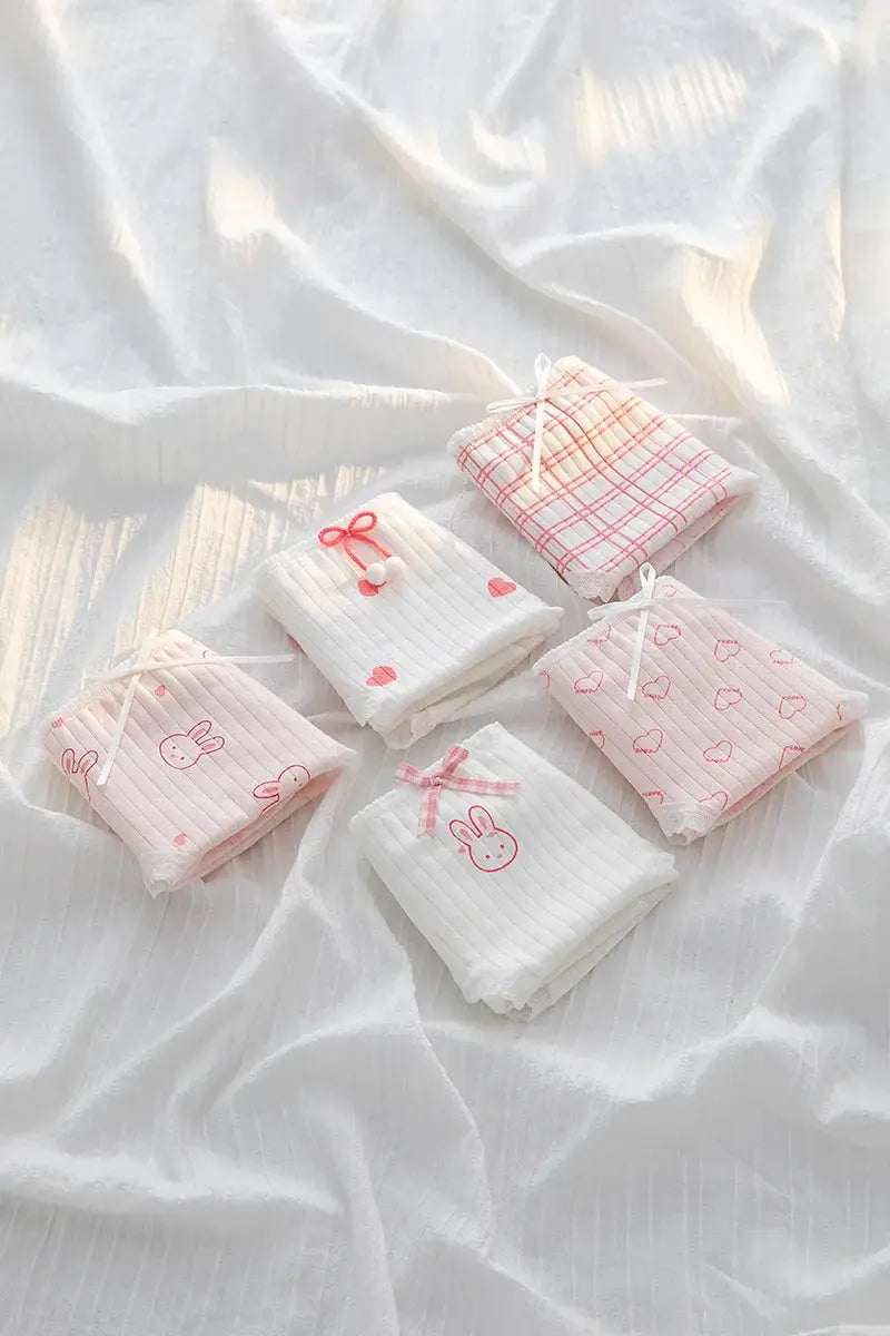 Simples Market 5-piece cotton underwear set; pastel pink/white briefs with bow accents and cute bunny/heart prints.