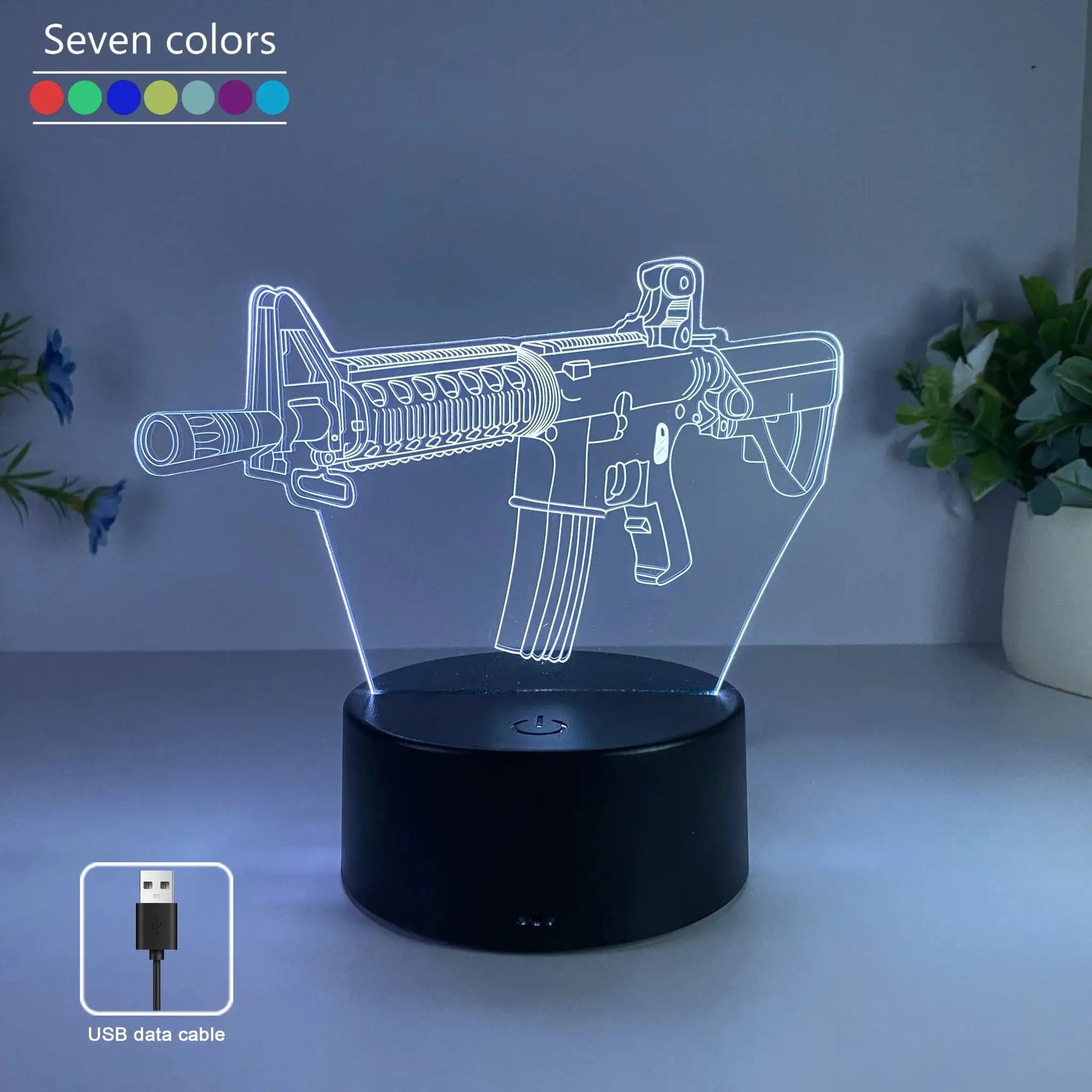Gun-shaped LED night light with seven-color RGB lighting, USB powered.