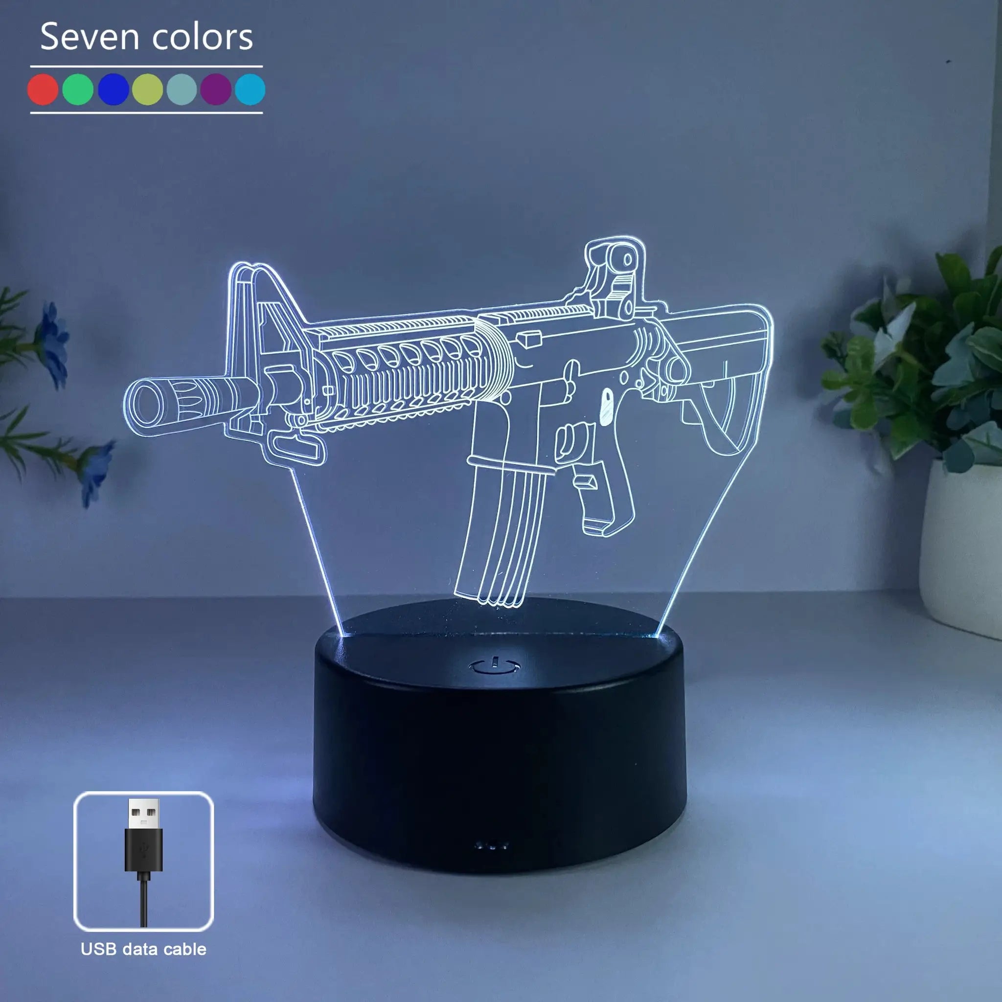 Gun-shaped LED night light with seven-color RGB lighting, USB powered.