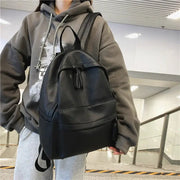 HOCODO fashion backpack in black PU leather; teen school bag with tassel zipper and top handle