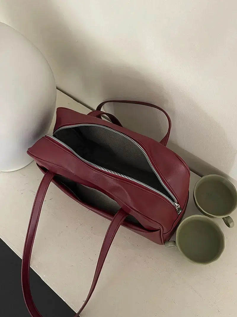 Korean-style large-capacity burgundy shoulder bag with top zipper, striped interior; also shown with two green mugs