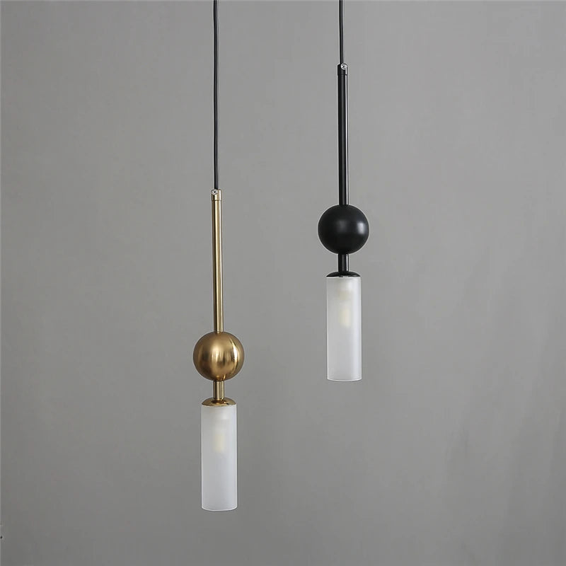 Pair of Nordic light luxury pendant lights in gold and black iron with frosted glass cylinders