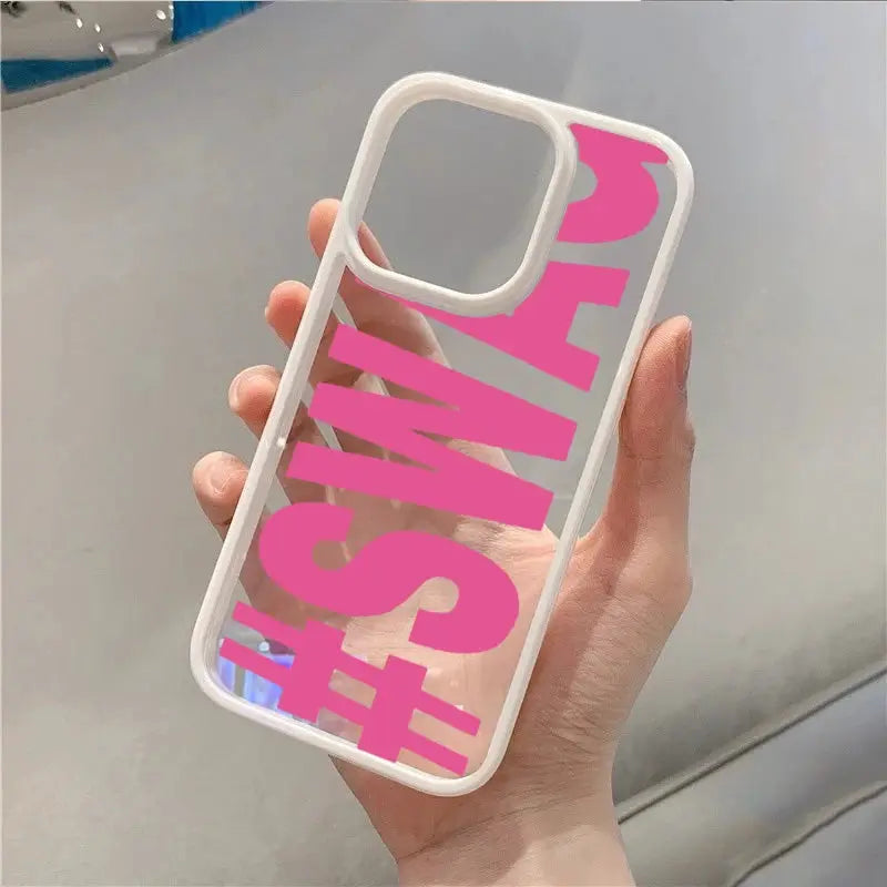 SWAG bold-letter iPhone case by Simples Market; clear back with bright pink typography and white shockproof bumper.