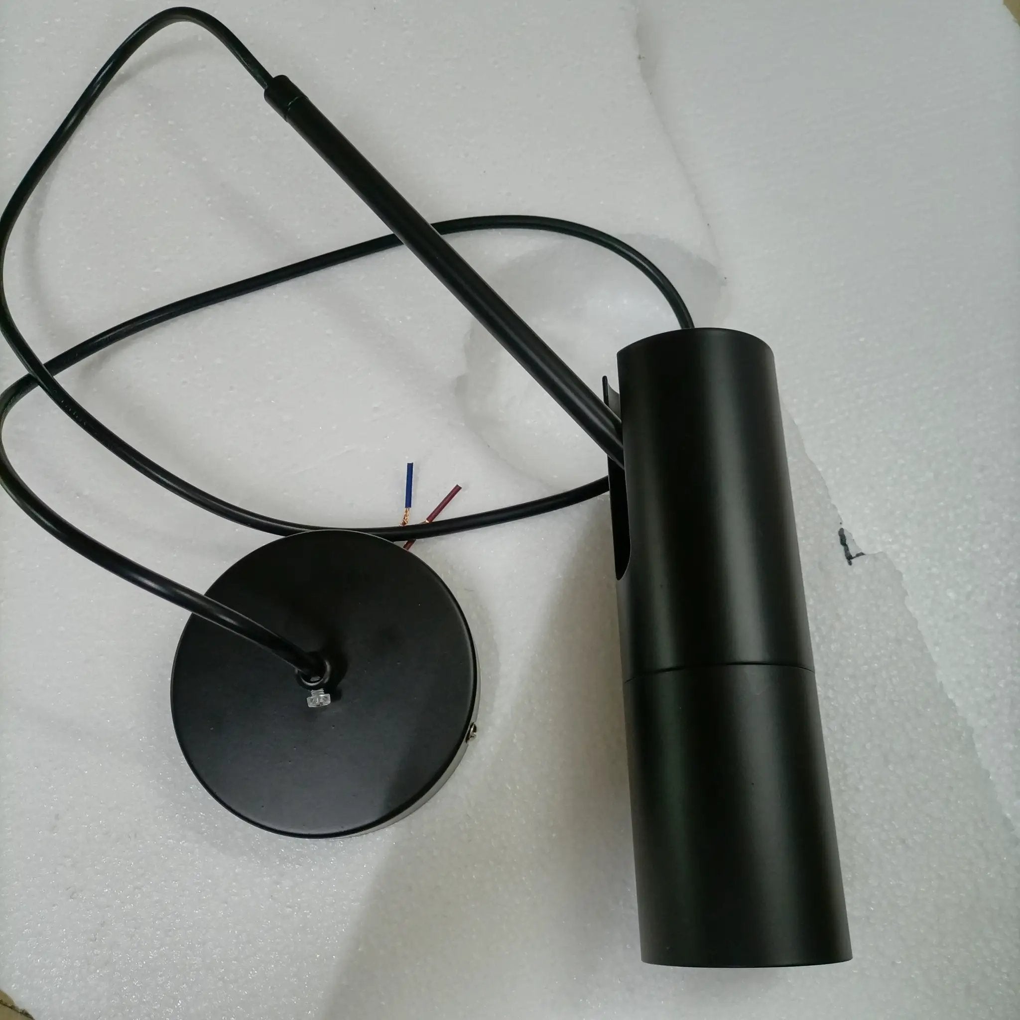 Minimalist black LED hanging pendant light by Simples Market with cylindrical shade and exposed wires