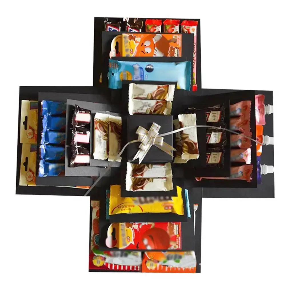 Explosion box gift by Simples Market with colorful candy packets on black layered panels and center bow