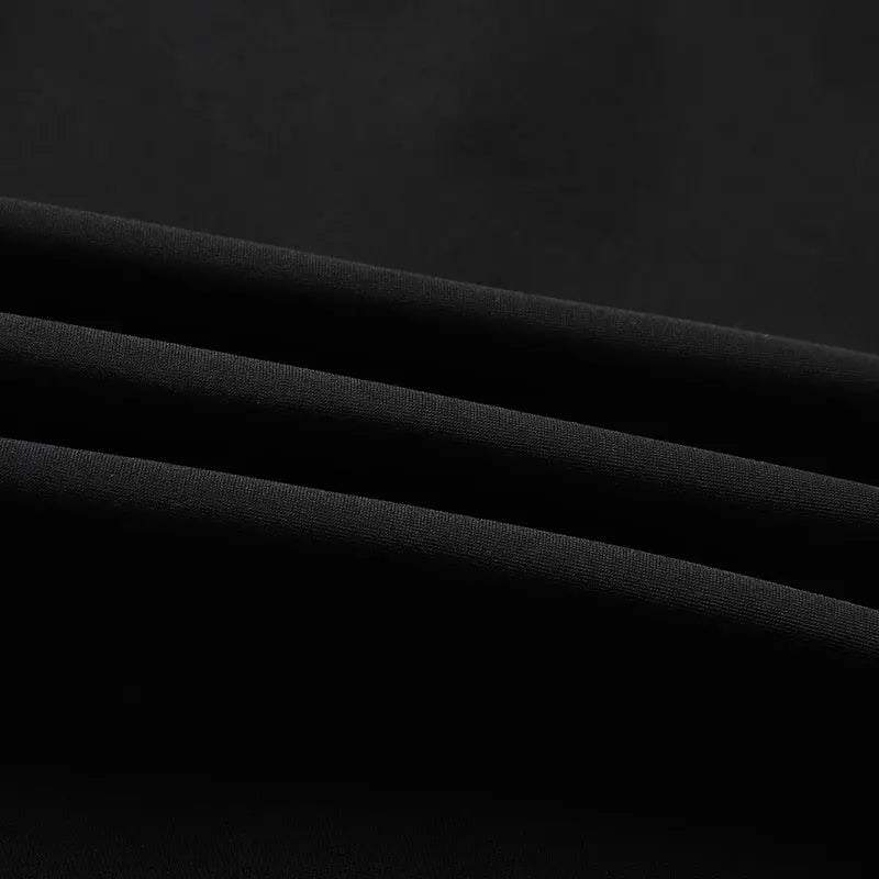 Men's black shorts fabric close-up; folded textile texture
