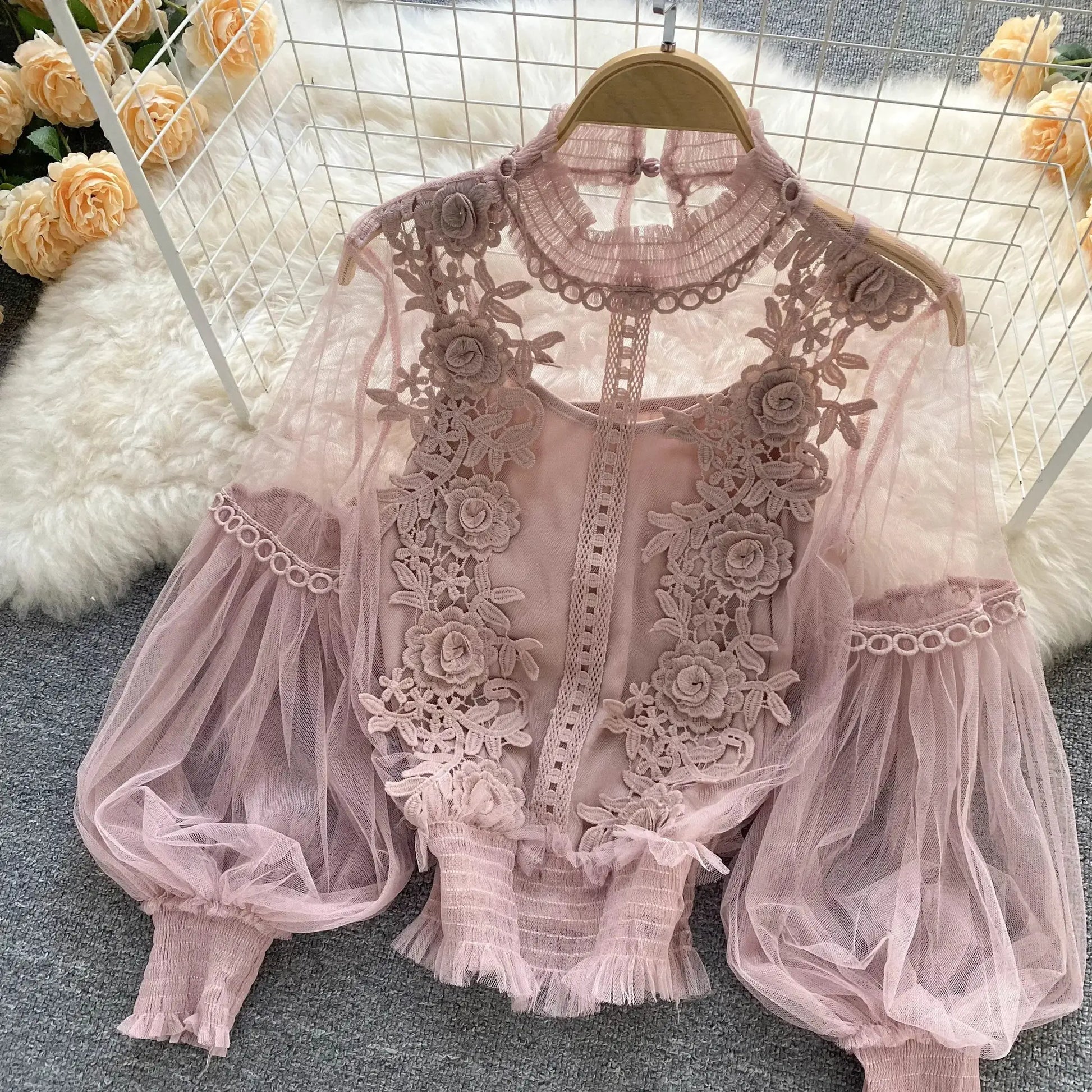 Lace puff long-sleeve blouse in dusty pink with floral appliqué and sheer mesh.