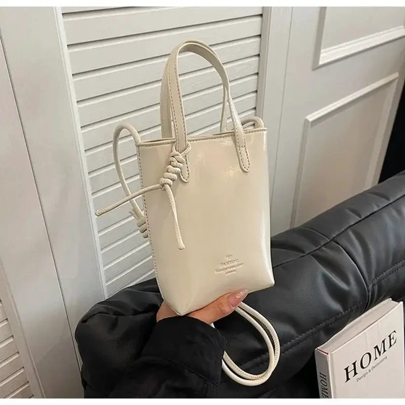 PU leather mini crossbody bag for women by Simples Market, cream with knotted drawstring and top handles.