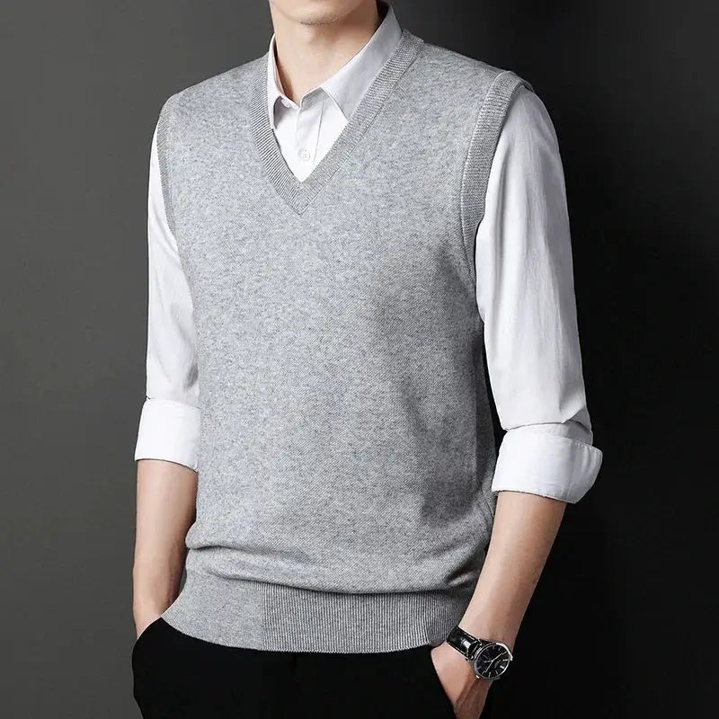 Men's gray V-neck knitted vest worn over a white dress shirt, casual versatile top
