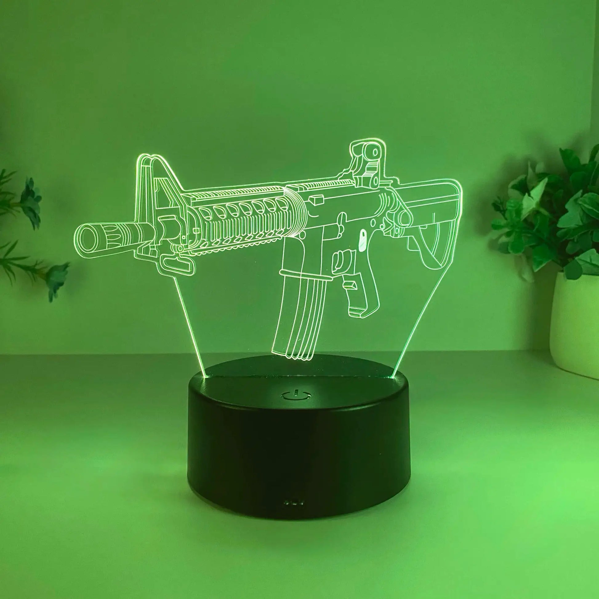 Submachine gun night light by Simples Market, USB-powered green neon acrylic silhouette on black base.