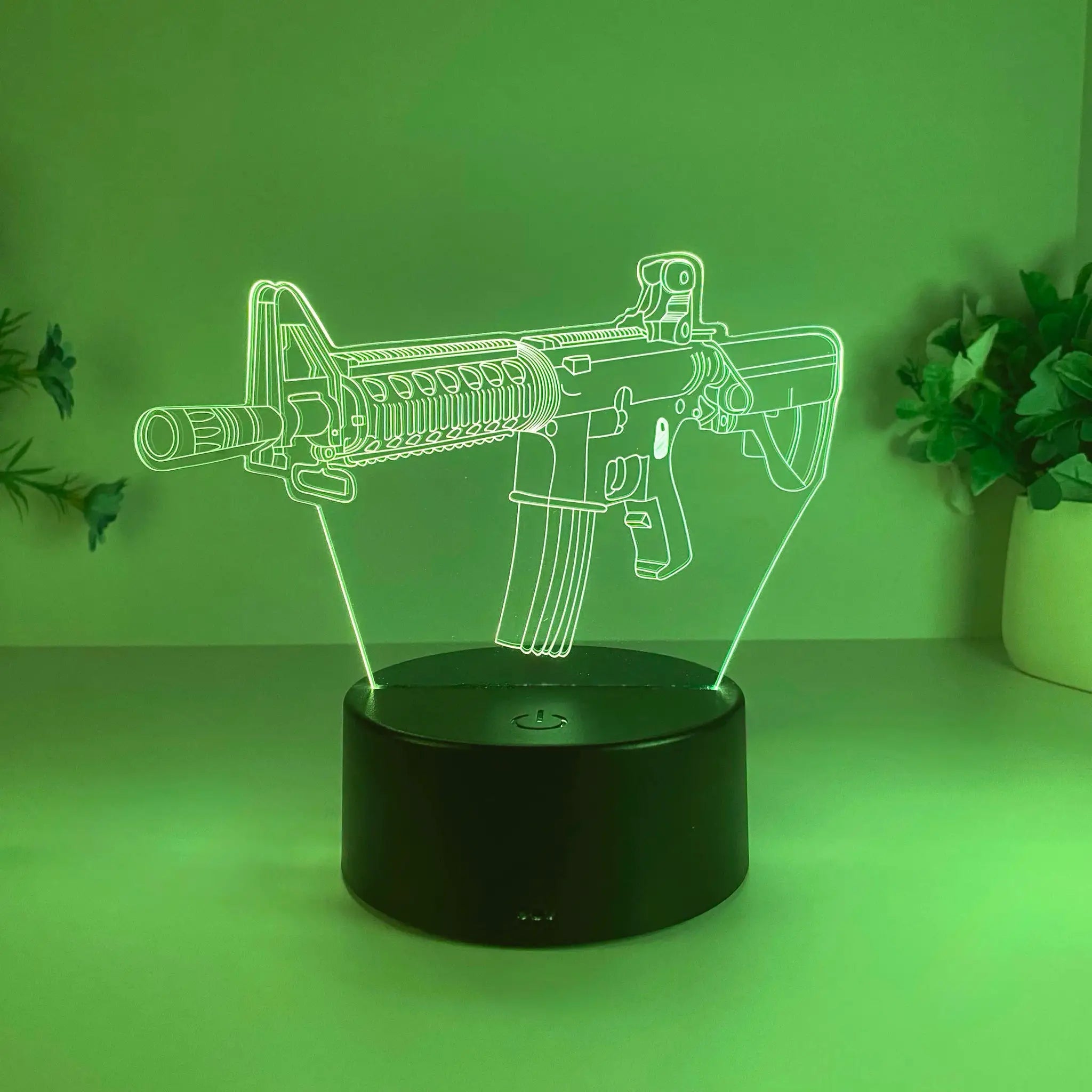Submachine gun night light by Simples Market, USB-powered green neon acrylic silhouette on black base.