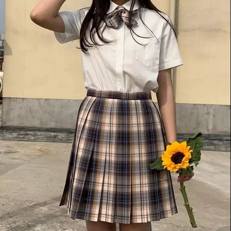 ZOKI plaid women's pleated high-waist skirt in beige and navy plaid, shown with a white blouse and bow tie