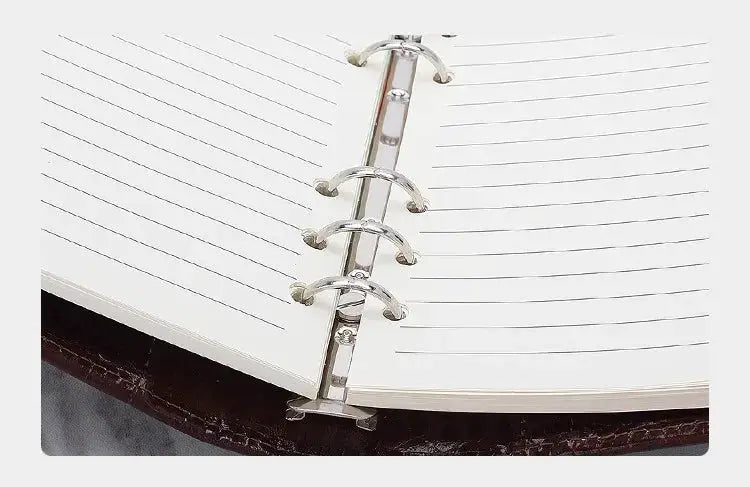 Pocket-size ring-bound planner with silver metal rings and lined pages