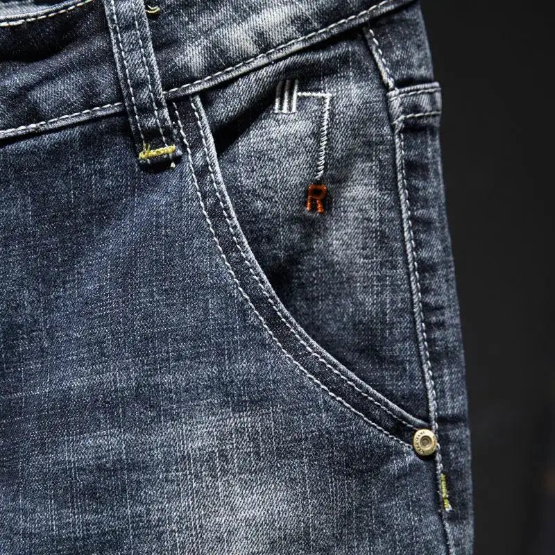 American elastic straight jeans for men in blue distressed denim with white stitching