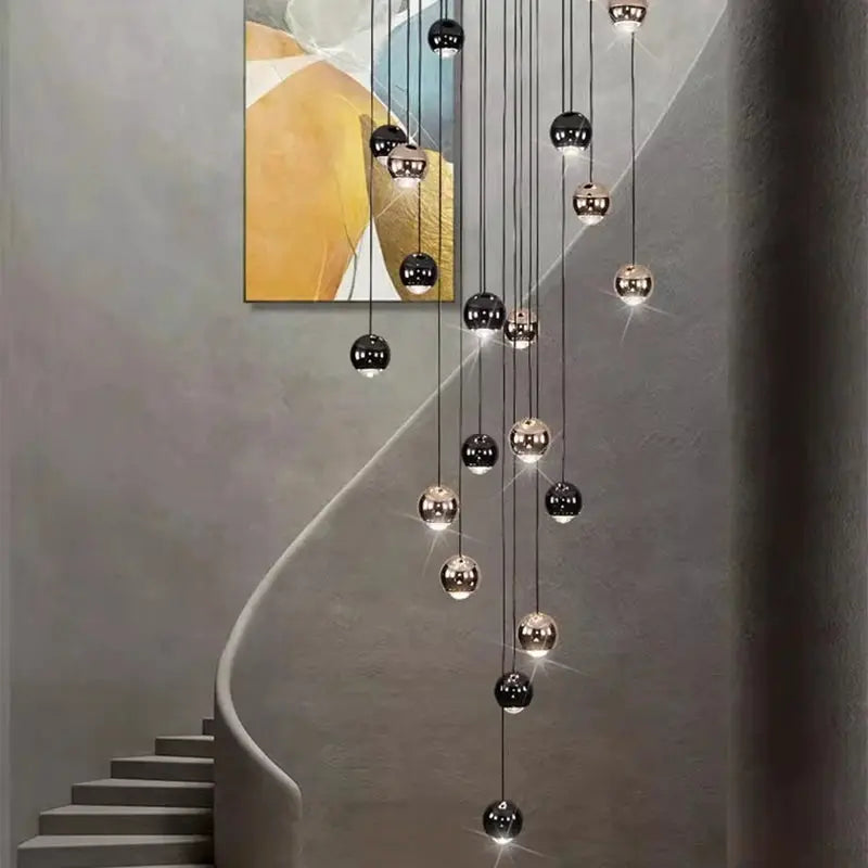 Multi-orb pendant light by Simples Market, hanging LED spheres in black and gold.