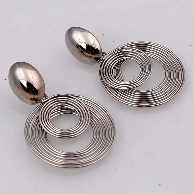 Large silver spiral hoop earrings with concentric rings and oval stud, geometric dangle jewelry