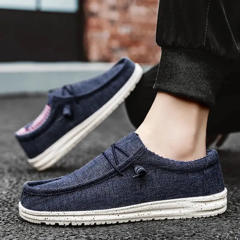 Men's navy canvas loafers with white speckled soles; breathable casual slip-on shoes, two shown in image