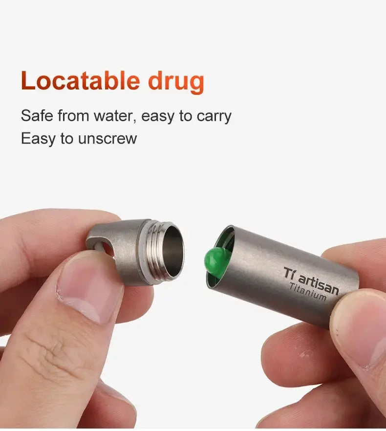 Tiartisan Titanium mini EDC pill bottle opened, showing a green pill; portable, waterproof container.