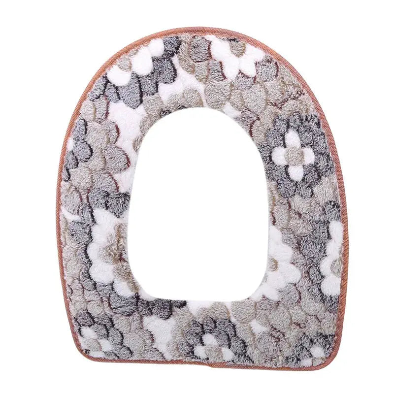 Plush toilet seat cover with a multicolor pattern and fuzzy texture, universal fit.