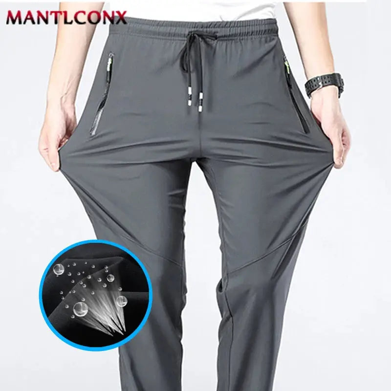 Breathable men's jogger pants, gray quick-dry fabric with elastic waist and zip pockets, MANTLCONX