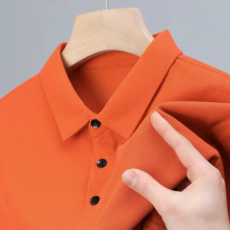 Men's orange polo shirt with classic collar, short sleeves and black button placket