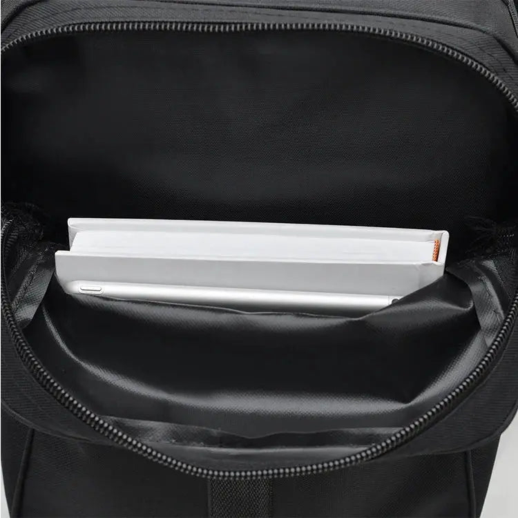 Simples Market black oversized backpack with multiple compartments; interior holds white notebooks.