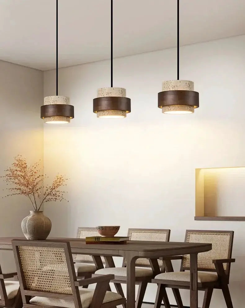 Three Japanese Wabi Sabi bar pendant lamps with speckled ceramic bodies and dark brown bands over a dining table