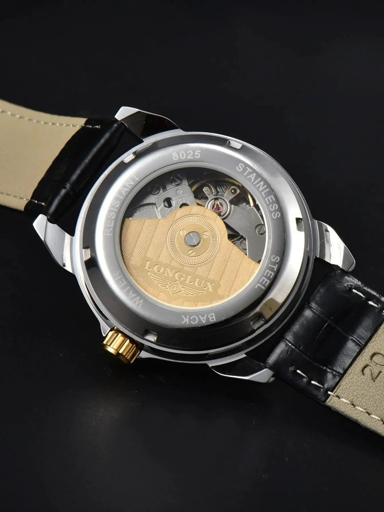 Men's automatic watch with stainless steel case back, black leather strap, visible gold rotor and LONGIUX movement
