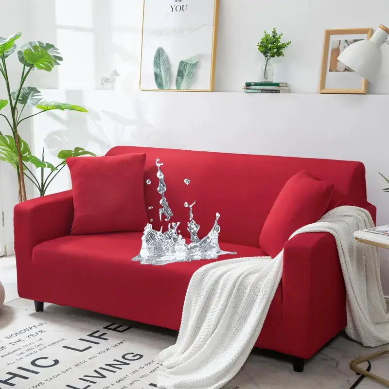 Red sofa in a bright living room with a white knit throw blanket.