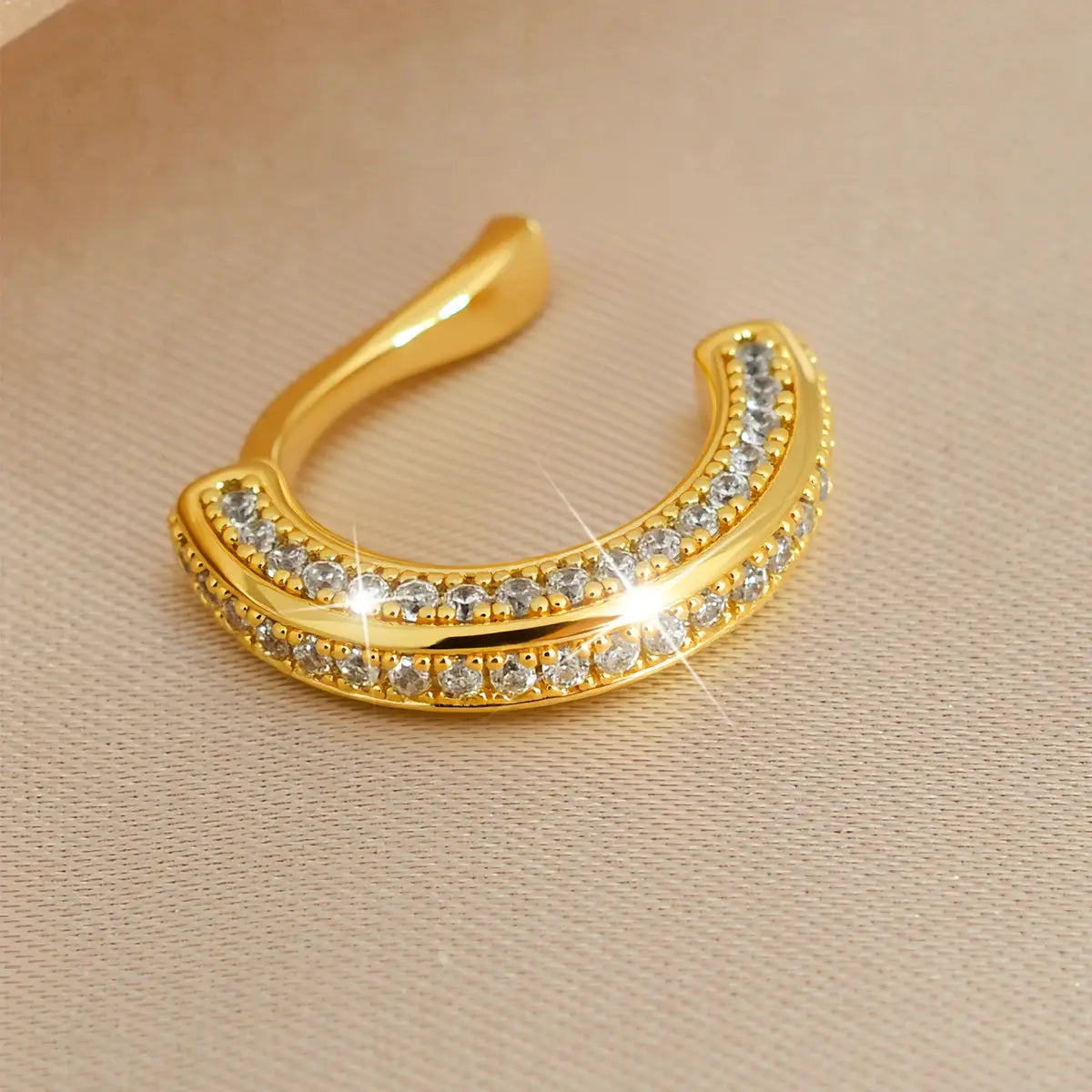 Clip-on ear cuff in gold-tone with two-row zircon stones in a crescent shape