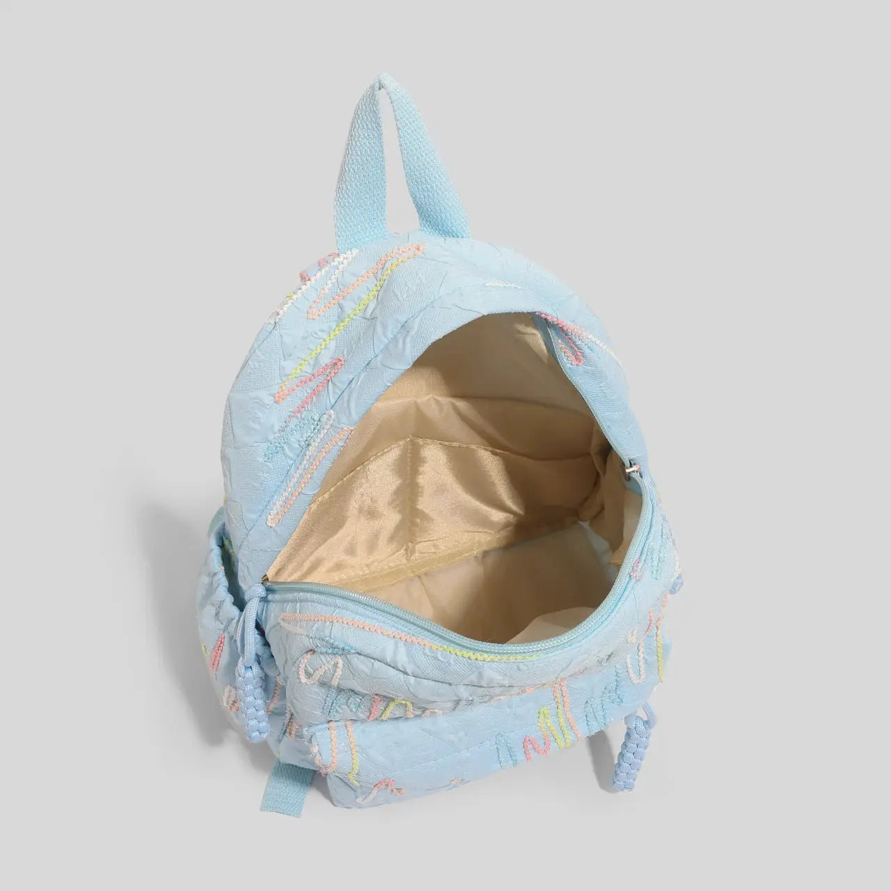 Simples Market women's mini backpack in light blue with pastel embroidery, zipper closure, beige interior
