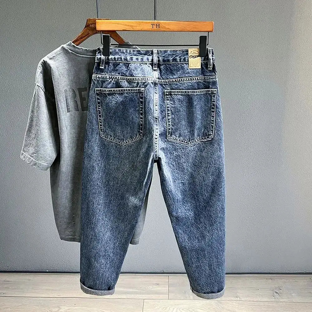Blue denim jeans by Simples Market, vintage loose tapered fit with back pockets; gray tee in background