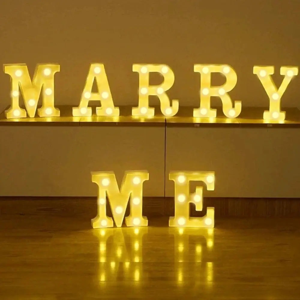 LED marquee letter lamp set by Simples Market, 7-letter warm-yellow glow spelling MARRY ME for home and party decor