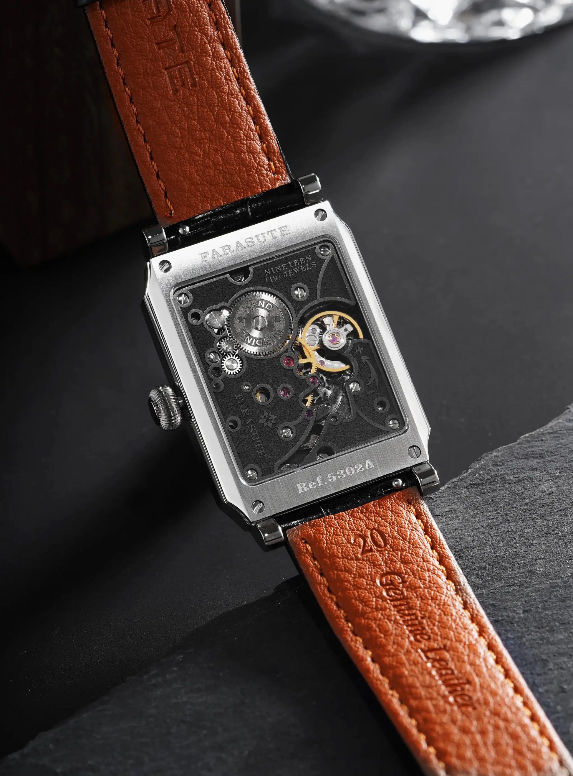 FARASUTE square mechanical wristwatch with brown leather strap and exposed gears.
