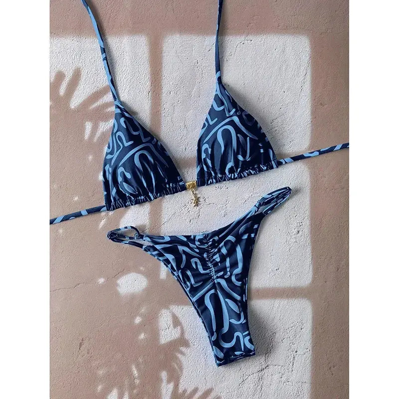 Simples Market blue abstract two-piece bikini with triangle top, string bottoms, and gold center charm