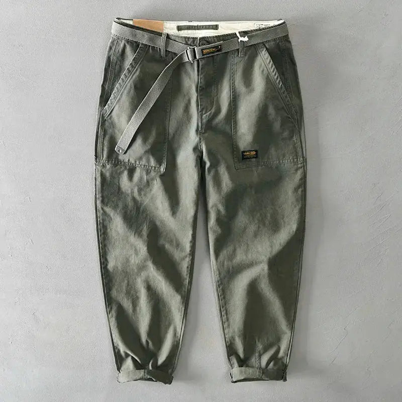 Men's olive green cargo pants with belt, front patch pockets and cuffed hems.
