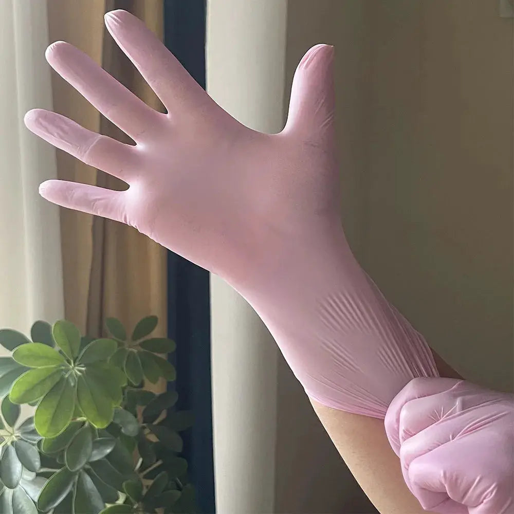 Light pink disposable nitrile glove on hand; waterproof and anti-static.