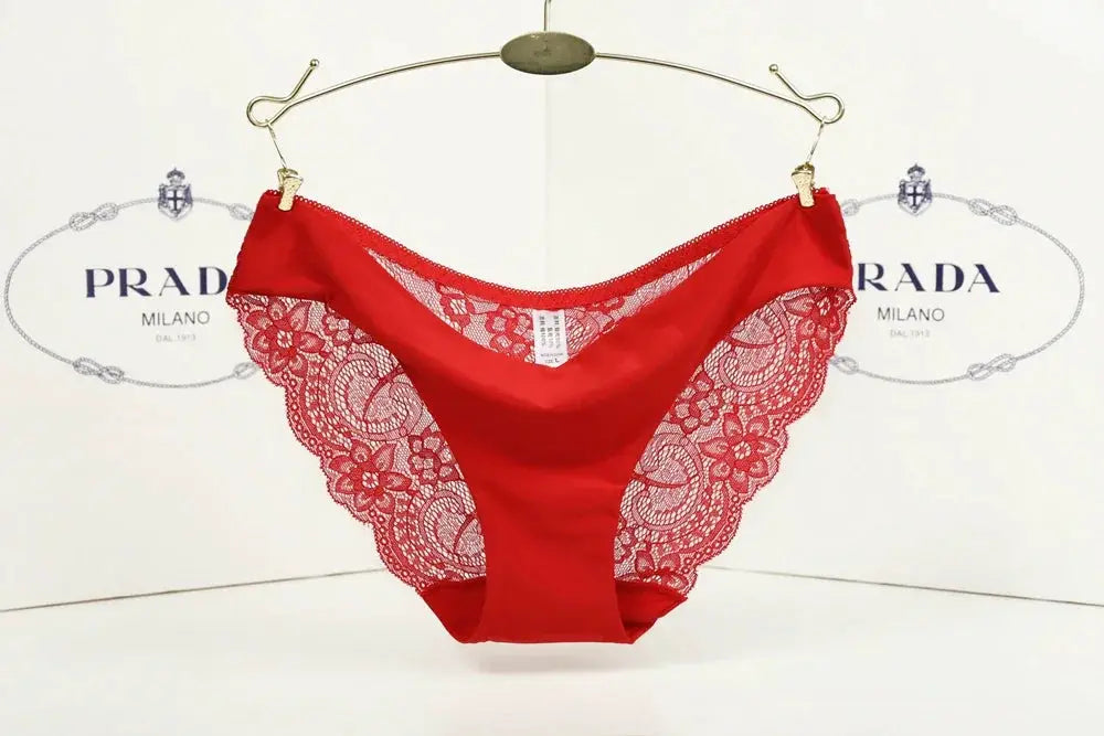 Simples Market red lace thong panties with scalloped floral lace sides, low-rise fit, Prada backdrop.