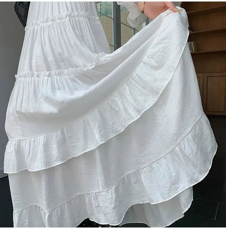 White tiered ruffle-hem maxi skirt with high waist and flowy chiffon layers.