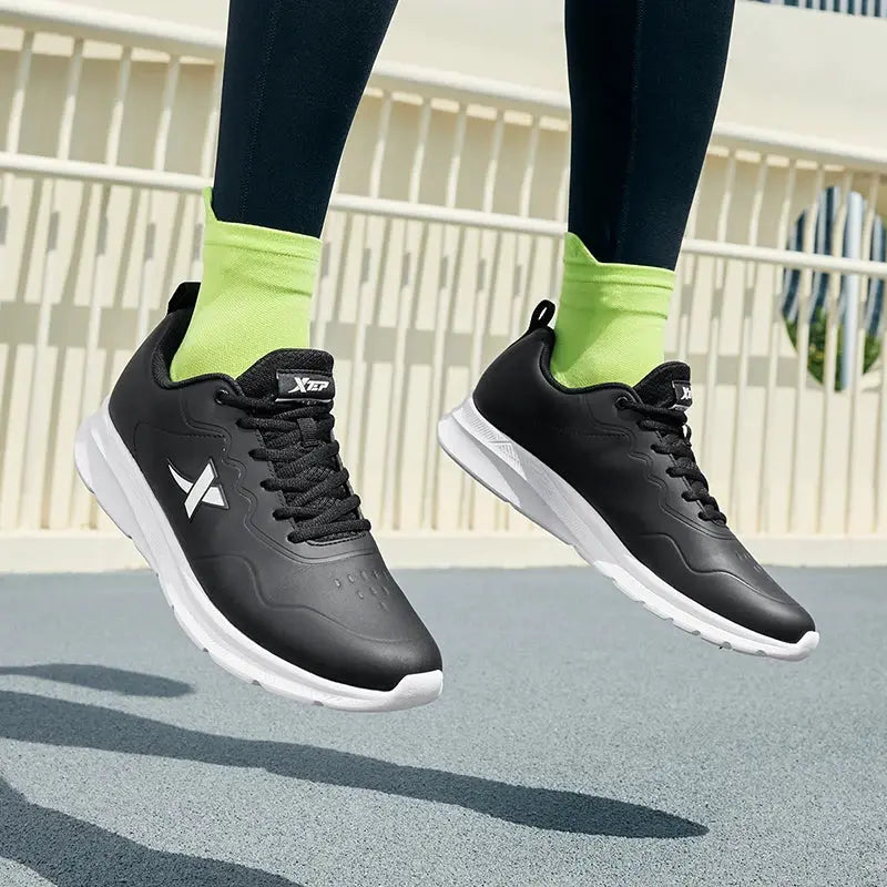 Xtep men's running shoes with black leather upper, white sole and visible logo on the side; pair shown.