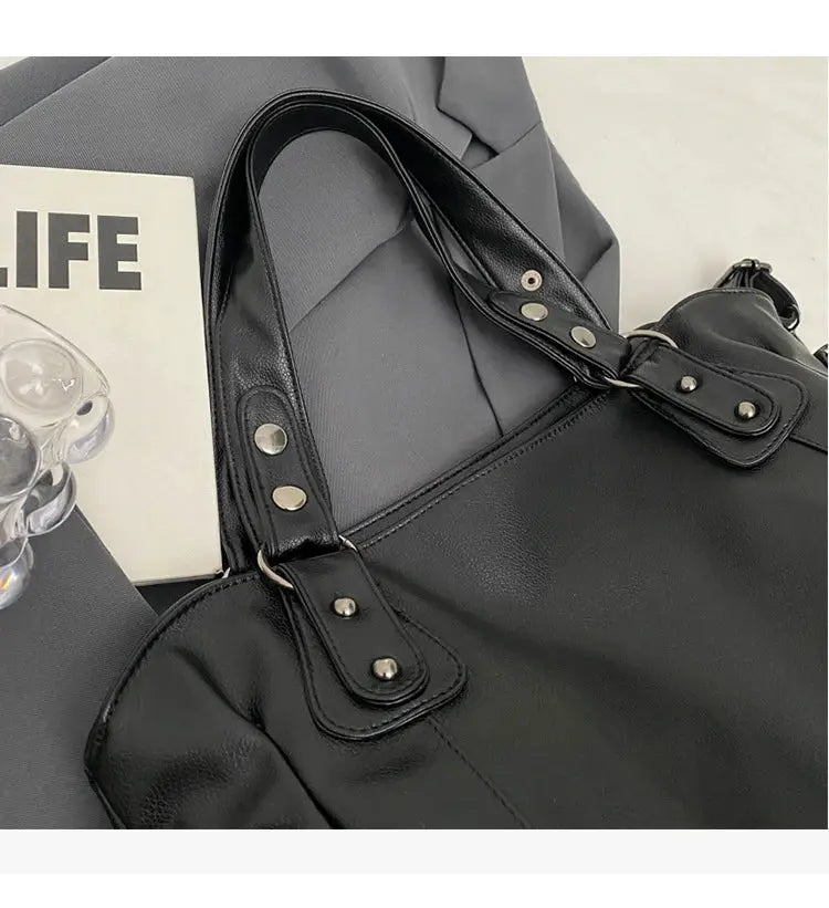 Shoulder bag by Simples Market in black PU leather with silver hardware and top handles