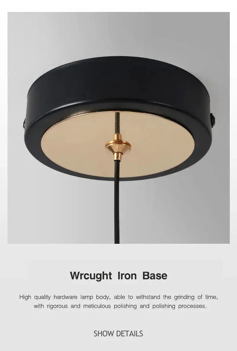 Pendant light round black wrought-iron ceiling fixture with gold underside and central hanging cord.