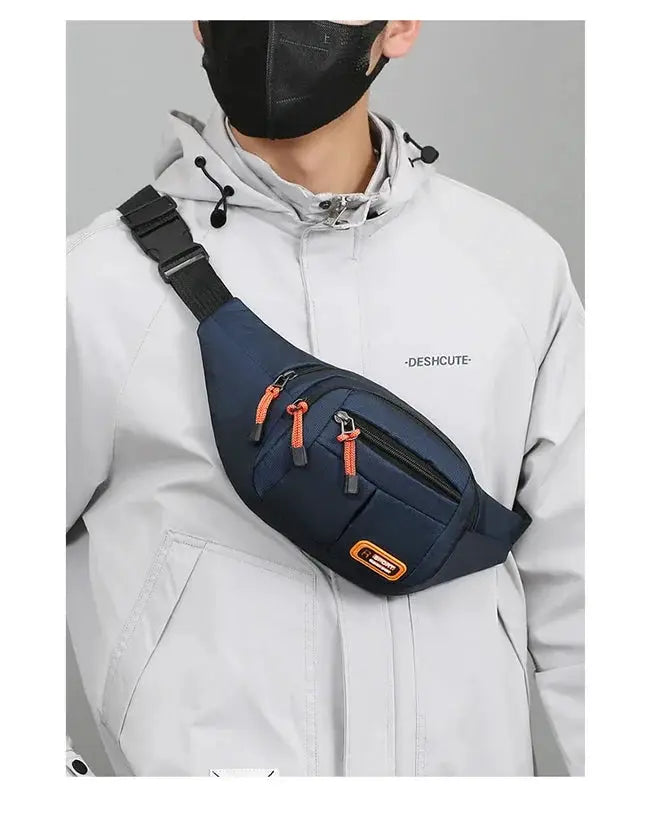 Oxford waterproof waist bag by Simples Market, navy with orange zipper pulls, worn across the chest.
