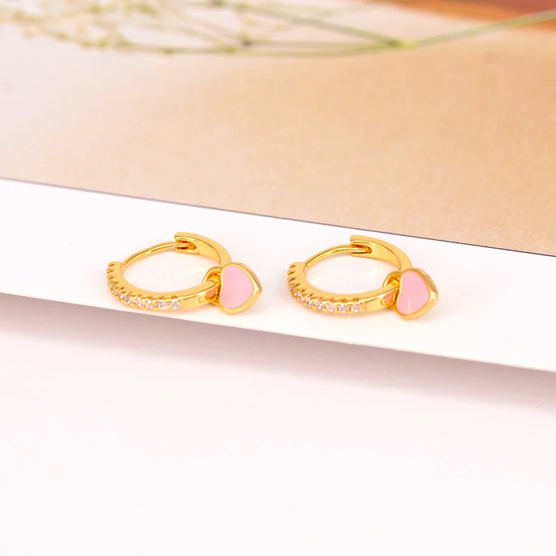 Gold-tone hoop earrings with pink enamel heart charms and zircon crystals, set of 2.